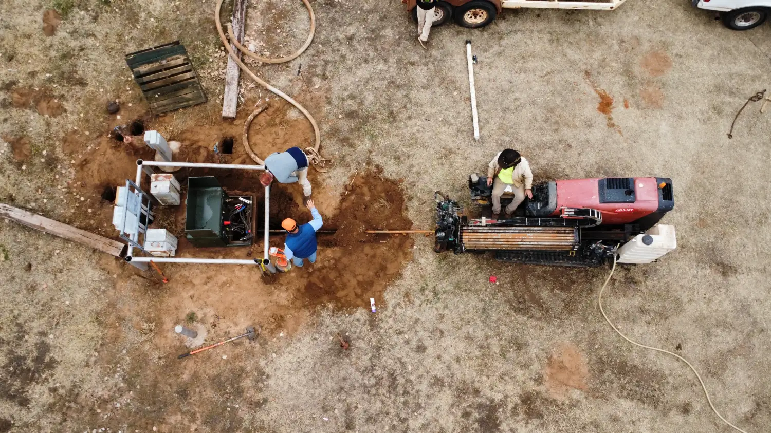 Aerial view of a Trinity Boring Solutions crew working a bore pit beside a directional drill rig in Oklahoma