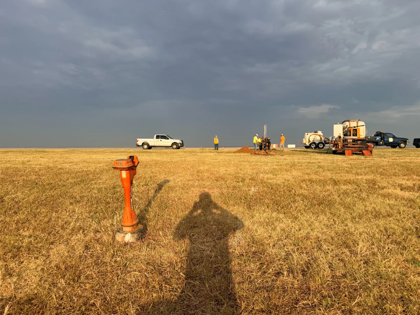 Trinity Boring Solutions crew working a navigational aid conduit bore at dusk at Will Rogers World Airport