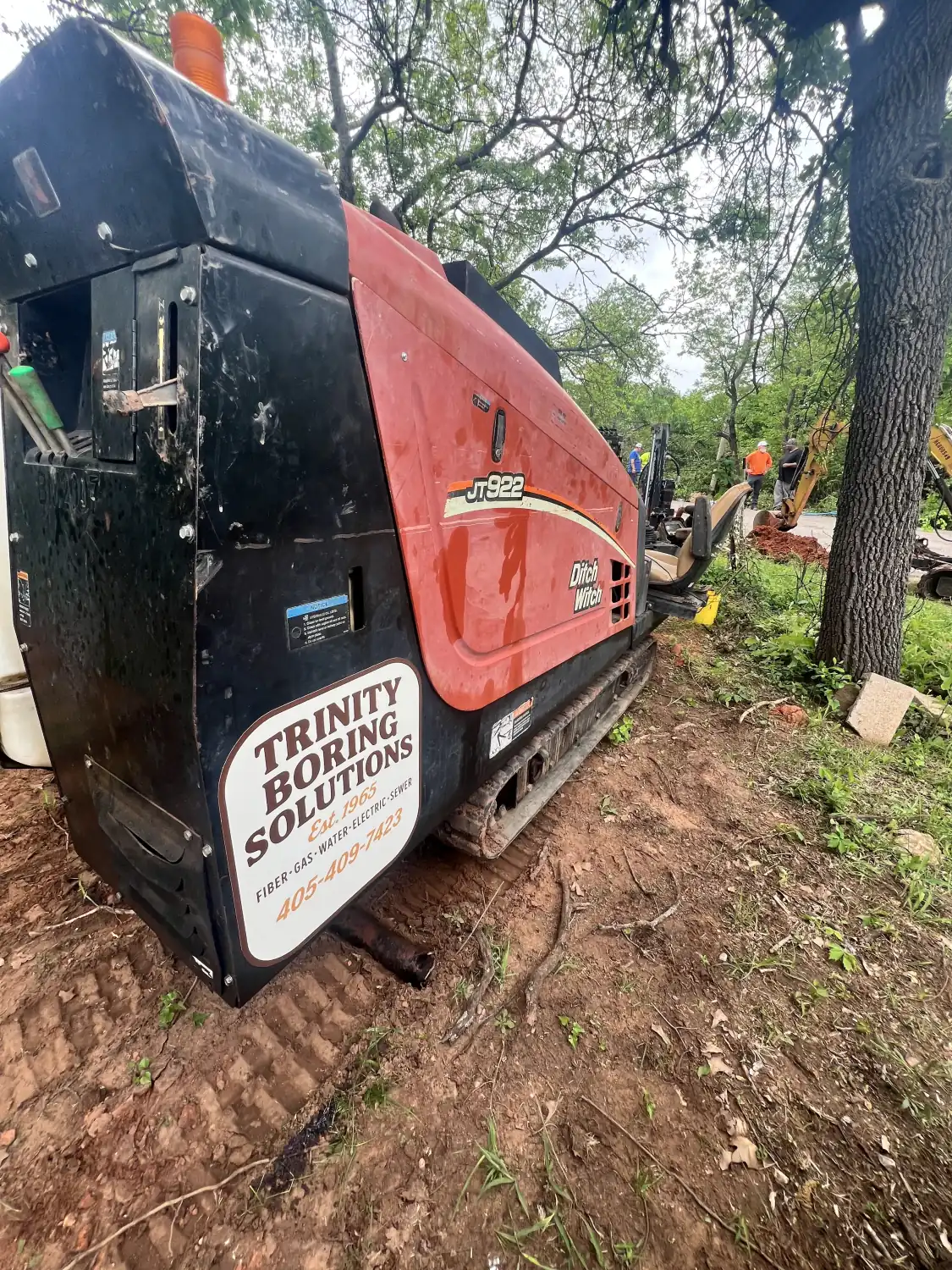 Trinity Boring Solutions branded compact directional drill unit on a red dirt Oklahoma jobsite